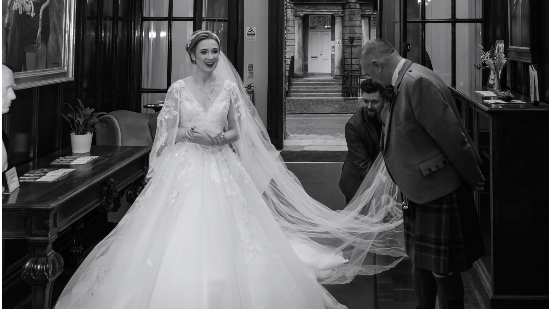 1599 team helping a bride fix her train and veil 
